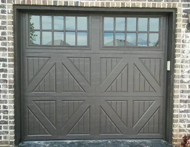 Carriage house crossbuck garage door on brick home installed by Affordable Door Co in OKC